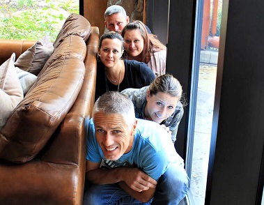 People are hiding behind the couch